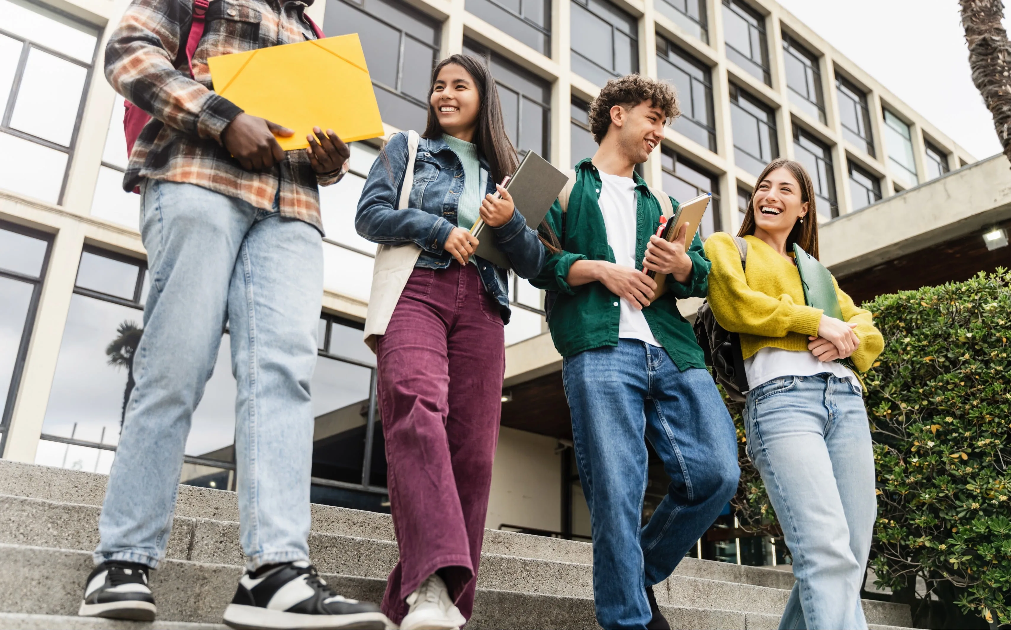 A group of young adults walking out of a school